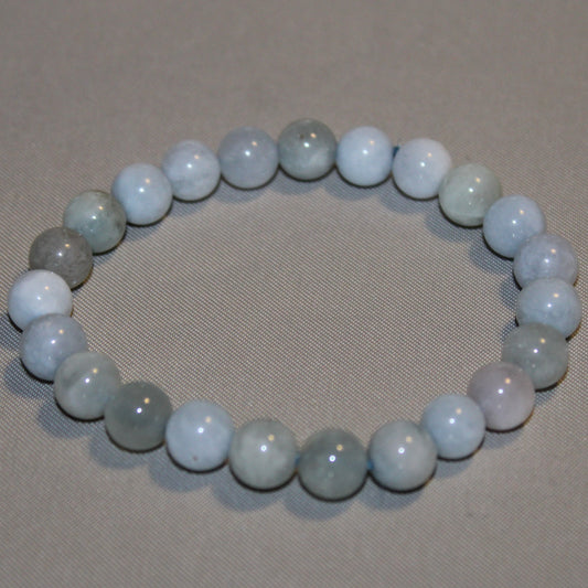 A collection of smooth, pale blue Angelite stones displayed on a white background, showcasing their soft color and gentle energy