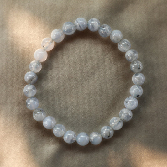 Soft blue Blue Lace Agate crystal with delicate lacy banding, symbolizing calm communication, emotional healing, and peaceful energy.