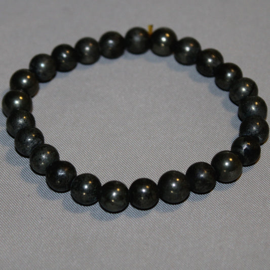 Polished Pyrite crystal beads with a metallic sheen, known for promoting abundance, protection, confidence, and vitality.