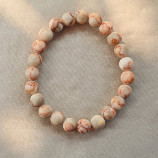 Polished Sesame Jasper crystal with soft green, white, and black speckled patterns—used for grounding, emotional healing, and peaceful energy.