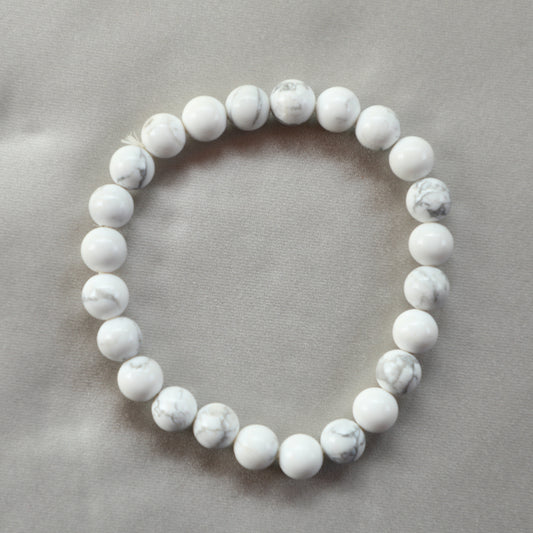 White Howlite crystal with soft gray marbling, symbolizing calmness, emotional healing, and spiritual awareness.