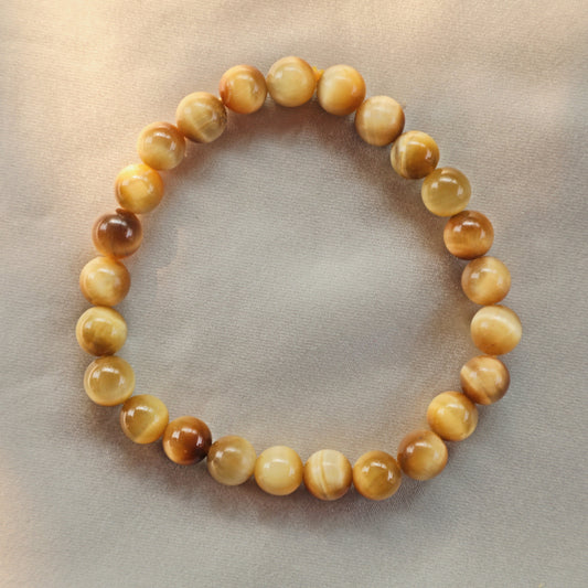 Yellow Tiger’s Eye crystal featuring golden and brown bands, symbolizing confidence, focus, and grounding energy.