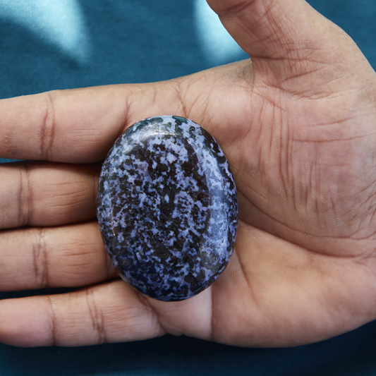 Polished Indigo Gabbro crystal with swirling shades of black and deep indigo, symbolizing spiritual awakening, transformation, and intuitive balance.