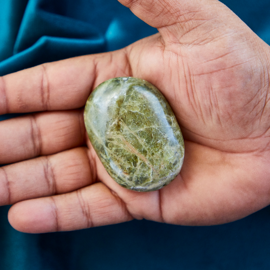 Polished green Serpentine crystal with natural earthy patterns, symbolizing healing, transformation, and connection to Earth energy.