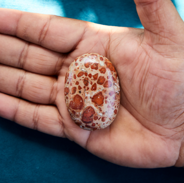 Mahogany Jasper crystal with deep red and brown tones, symbolizing grounding, strength, and emotional stability.