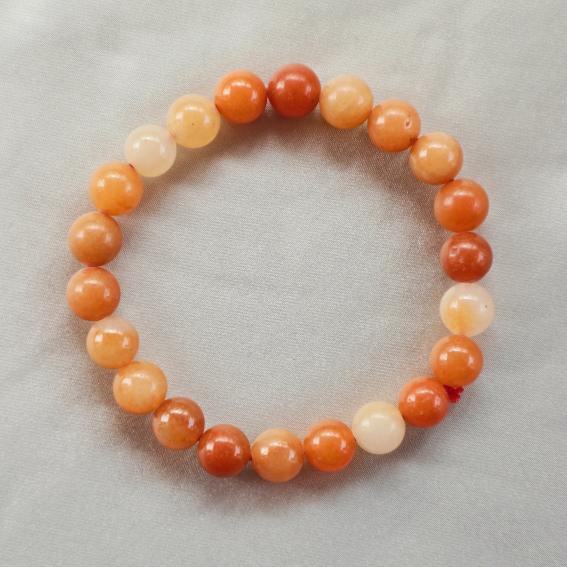 Polished Carnelian bracelet with vibrant orange and red hues, symbolizing vitality, creativity, and motivation