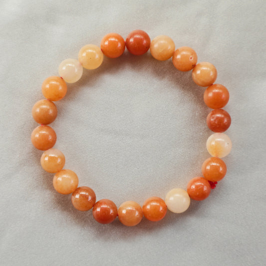 Polished Carnelian bracelet with vibrant orange and red hues, symbolizing vitality, creativity, and motivation